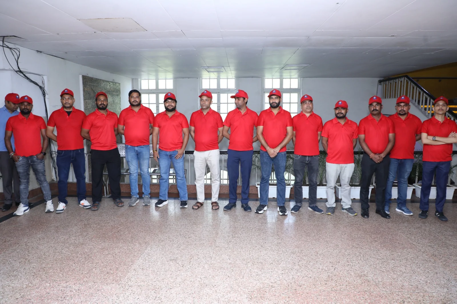 Professional cleaning workers in red uniforms during the awareness programme